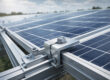 Aluminium end clamp securing solar panel edge on mounting rail for rooftop installation
